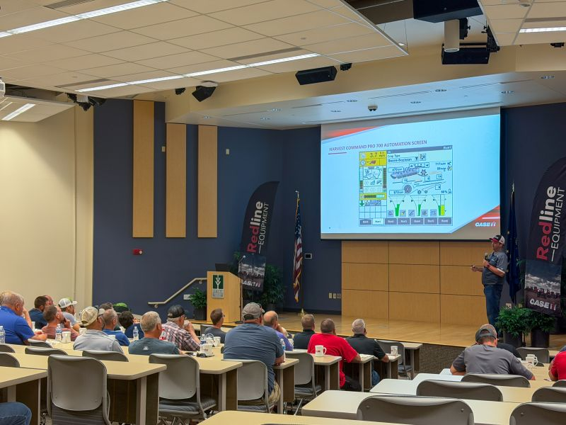 A specialist presents the Harvest Command Pro 700 automation screen at a Redline Harvest Ready event